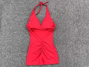 Detail of red backless yoga jumpsuit with halter neck and scrunch butt stitching details