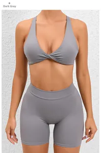 Detail of dark grey yoga set featuring a twist-knot sports bra and high-waist biker shorts