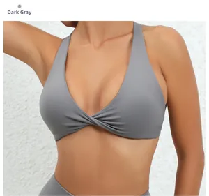 Detail of dark grey yoga bra featuring a stylish twist knot and cross neck design