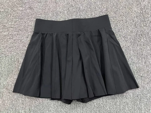 Détail à plat d'une jupe de tennis plissée noire avec taille élastique et short intégré