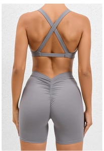 Detail of grey yoga set featuring cross-back bra and scrunch butt lifting shorts