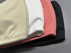 Close-up of seamless knitted yoga bra fabric showing elastic texture in four colors