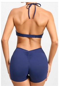 Detail of navy blue high-waist yoga shorts with scrunch butt lift effect at the back