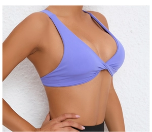 Detail of purple V-neck yoga bra featuring twist knot design and wide shoulder straps