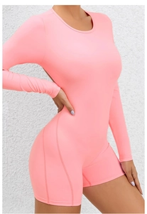 Close-up of structured side seams and matte fabric on this pink long-sleeve yoga bodysuit