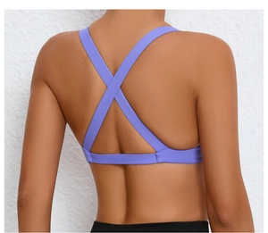 Close-up of purple sports bra featuring cross-back straps and elastic underband detail