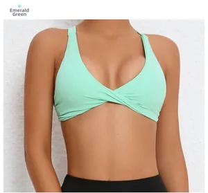 Close-up of emerald green sports bra featuring a stylish twist-knot front and halter straps