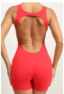 Detail view of red one-piece yoga jumpsuit with an open back design and elastic fabric