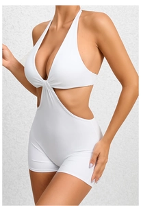 Detailed view of white cutout one-piece yoga jumpsuit with halter neck and waist hollow design