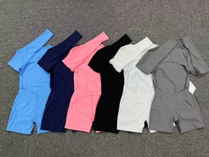 Detailed backless design of six-color long sleeve athletic bodysuits on grey carpet
