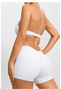 Detail view of white backless yoga romper showing high-waisted scrunch butt lifting design