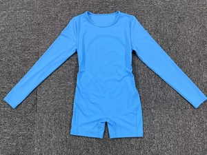 Flat lay close-up of sky blue long-sleeve athletic bodysuit with round neck and tight fit