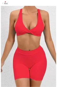 Detail of red sports set featuring V-neck twist knot sports bra and high waist biker shorts