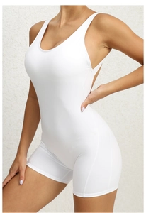 Detail of white one-piece yoga bodysuit with U-neck and wide straps on female model