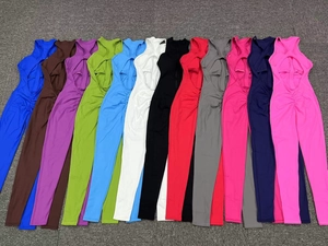 Flat lay of sleeveless yoga bodysuits in 12 vibrant colors featuring hollow-out cutouts