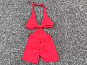 Detail of red hollow-out yoga bodysuit featuring halter neck and ruched butt lift design