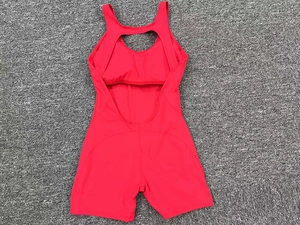 Detail of red athletic one-piece yoga jumpsuit with racerback and high elasticity fabric