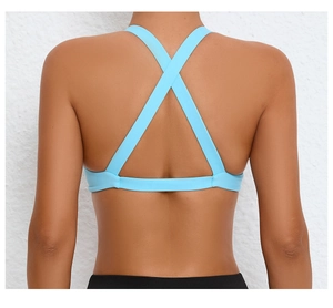 Detail view of the bright blue sports bra featuring a criss-cross back and elastic band
