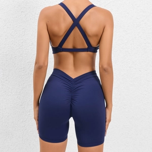 Women's dark blue yoga set with cross back sports bra and high waist scrunch shorts