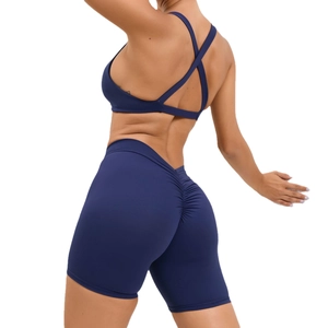 Dark blue two-piece yoga set with crisscross back sports bra and ruched butt-lifting shorts