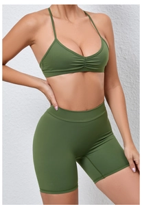 Detail of olive green yoga set with pleated sports bra and high-waist biker shorts