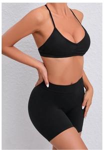Detail of black V-neck sports bra and high-waist biker shorts in quick-dry fabric