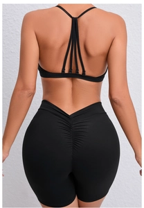 Detail view of black yoga set featuring V-shaped high waist and scrunch butt gym shorts