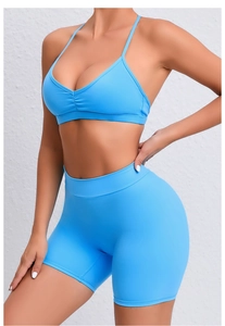 Detail of light blue quick-dry yoga set showing thin straps and high-waisted fitness shorts