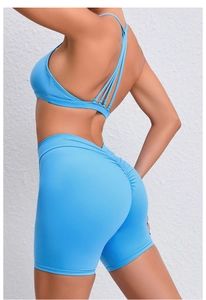 Detail view of high-waist yoga shorts featuring scrunch butt design in light blue fabric