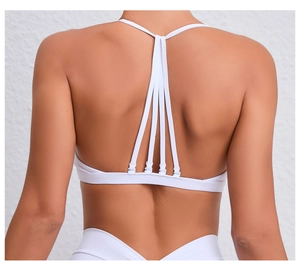 Détail du dos d'un soutien-gorge de yoga blanc avec fines bretelles croisées géométriques