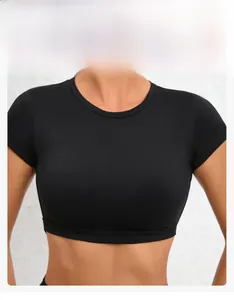 Close-up of black slim fit yoga top showing breathable quick-dry fabric and waist detail