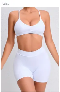 Close-up of white quick-dry yoga set featuring thin strap sports bra and high waist shorts