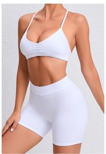 Close-up of white yoga set featuring a V-neck sports bra with thin adjustable straps