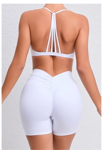 Detail of cross back straps and scrunch butt lifting effect on white yoga set