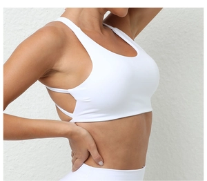 Close-up of white sports bra with wide straps and breathable side cutout details