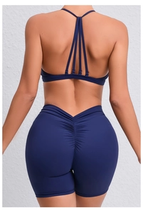 Detail of cross-back yoga bra and scrunch butt gym shorts in deep blue high-stretch fabric