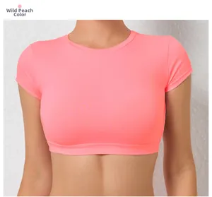 Detailed close-up of quick-dry yoga crop top in wild peach color with a slim fit