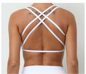 Close-up of white yoga bra featuring a stylish multi-strap criss-cross back design