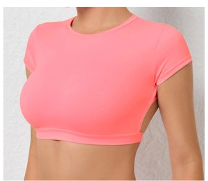 Detail of neon pink crop top featuring hollow-out back design for workout breathability