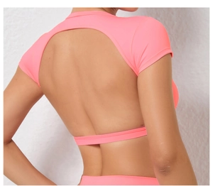 Close-up of pink quick-dry yoga top featuring a stylish open back design and elastic fabric