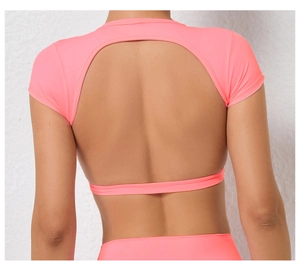 Detail of cross-back design and breathable pink fabric on this athletic yoga crop top