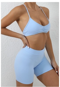 Detail of light blue quick-dry yoga set showing ribbed bra texture and high-waist shorts