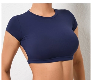 Detail of navy blue cropped yoga top with back cutout and breathable fabric texture