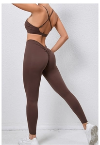 Détail de la brassière croisée et du legging push-up dans l'ensemble fitness marron