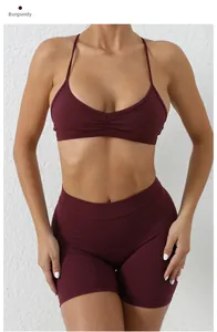 Detail view of wine red yoga bra with ruched chest design and removable straps