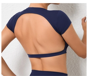 Macro shot of dark blue yoga top featuring an oval cutout back and elasticated hemline