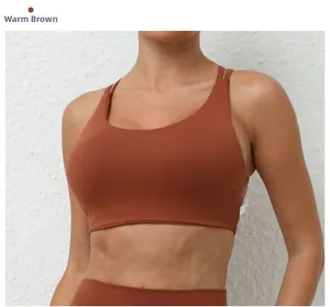 Close-up of warm brown quick-dry sports bra with criss-cross back straps and matte texture