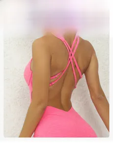 Dettaglio delle fibbie incrociate regolabili sulla schiena della tuta da yoga rosa