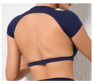 Detail of navy blue yoga top featuring circular open back cutout and elastic fabric