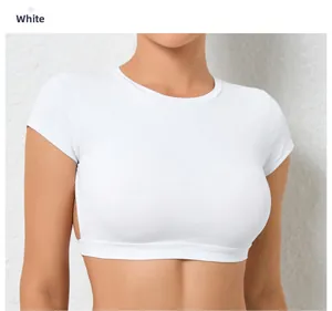 Detail of white tight yoga crop top showing high elastic fabric and crew neck design